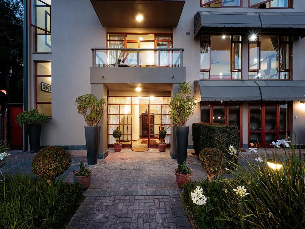 A large building with a brick walkway leading to it