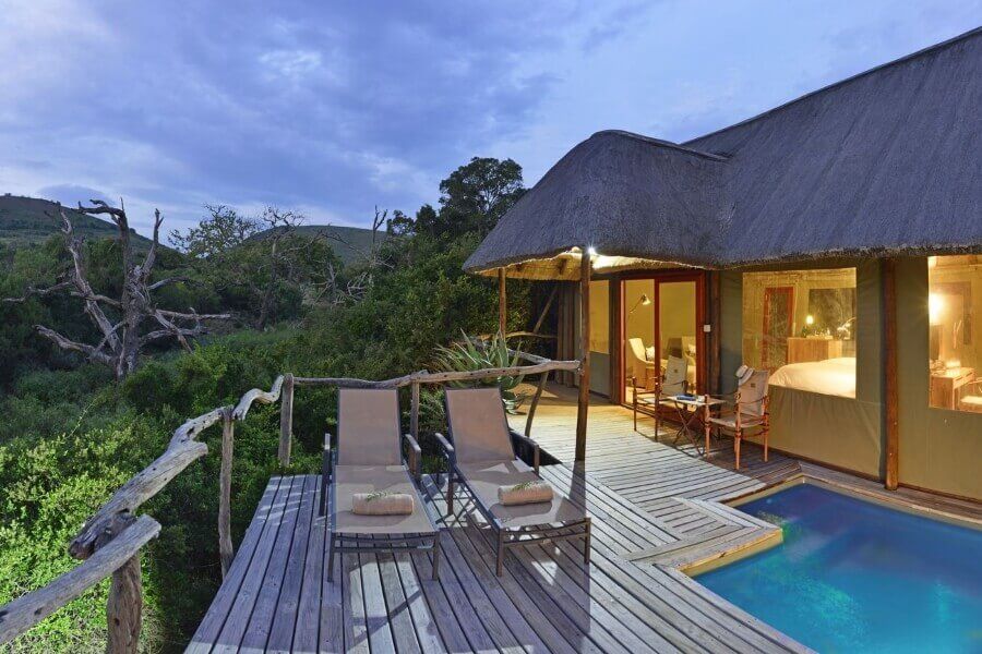 There is a swimming pool in front of a house.