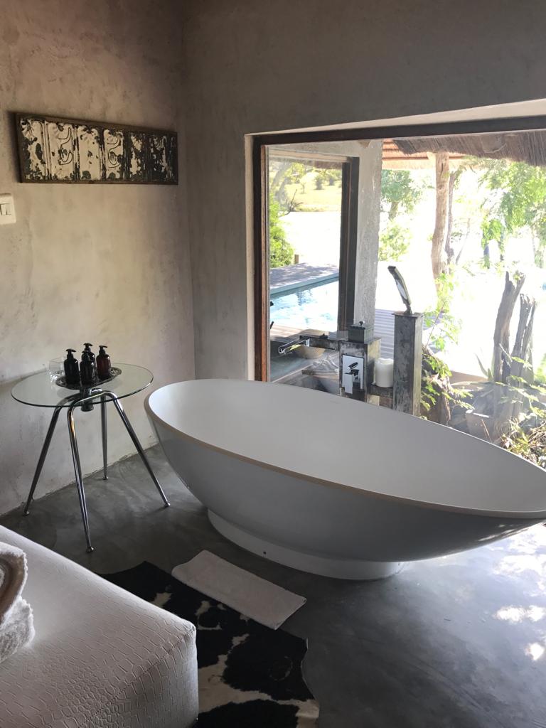 A bathroom with a large bathtub and a sliding glass door.