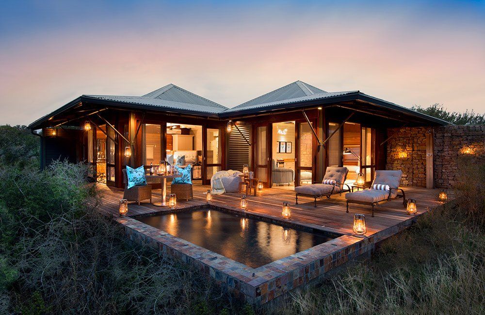 A large house with a swimming pool in front of it.