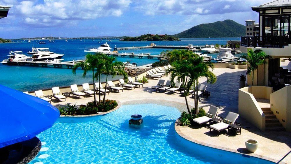 A large swimming pool with a view of the ocean