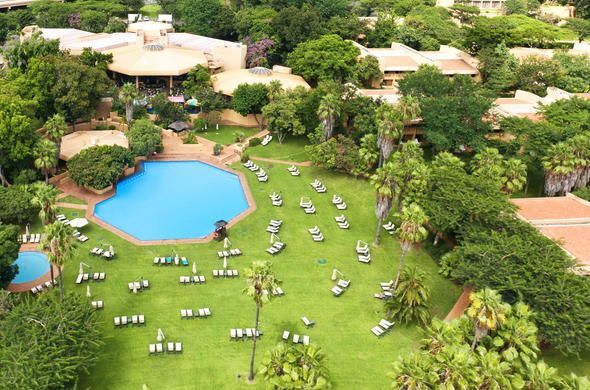 An aerial view of a resort with a large swimming pool