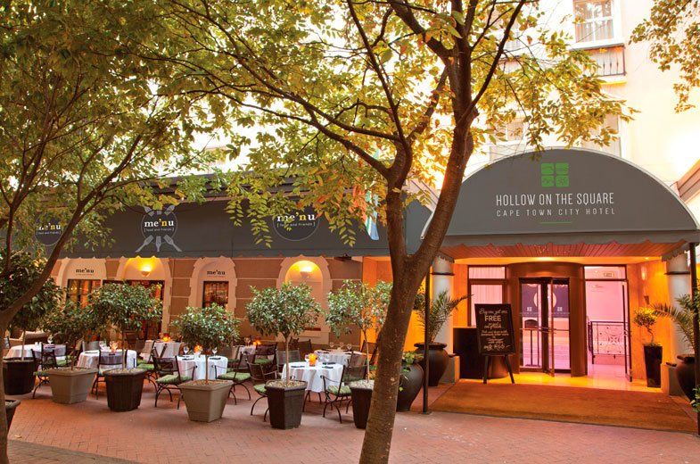A restaurant with tables and chairs in front of it