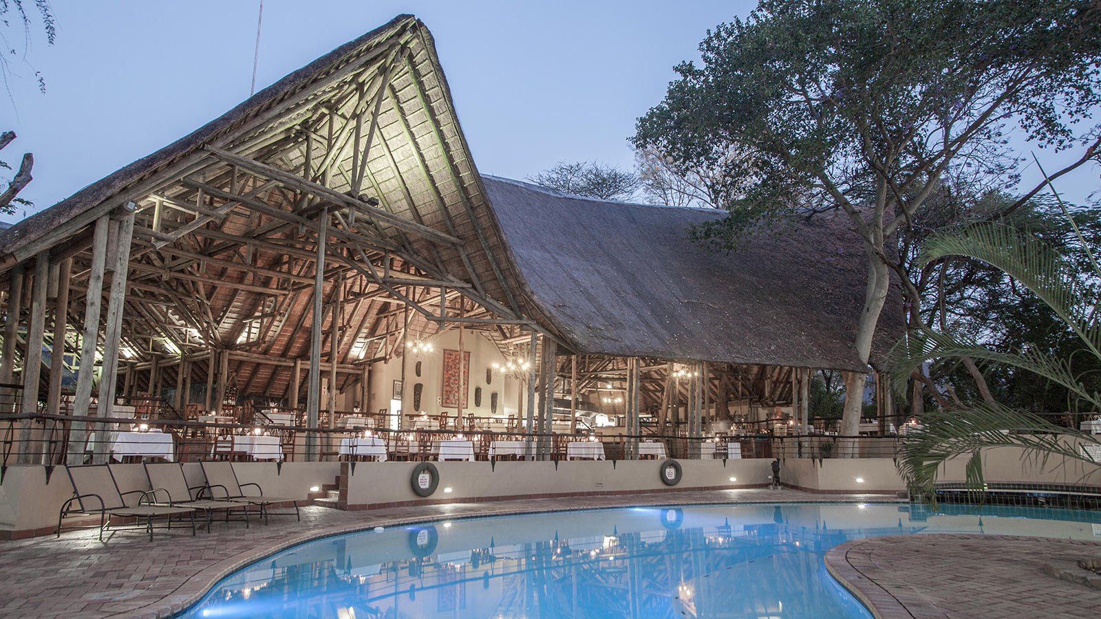 A large building with a swimming pool in front of it.
