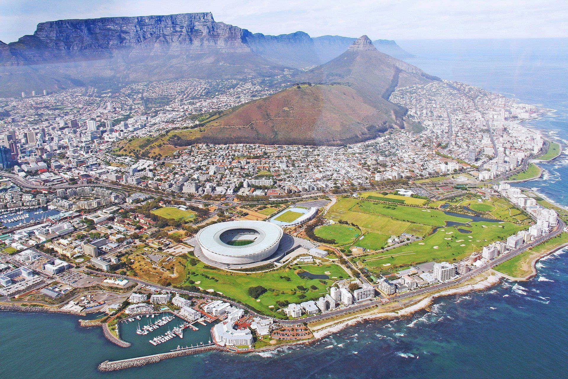 An aerial view of a city with a mountain in the background