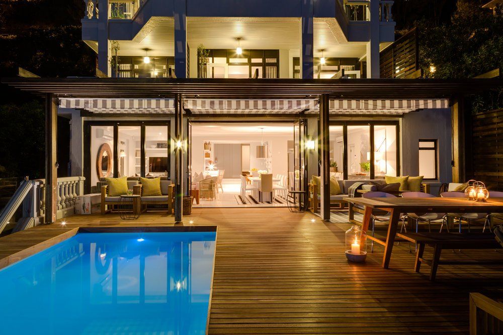 A large house with a swimming pool in front of it