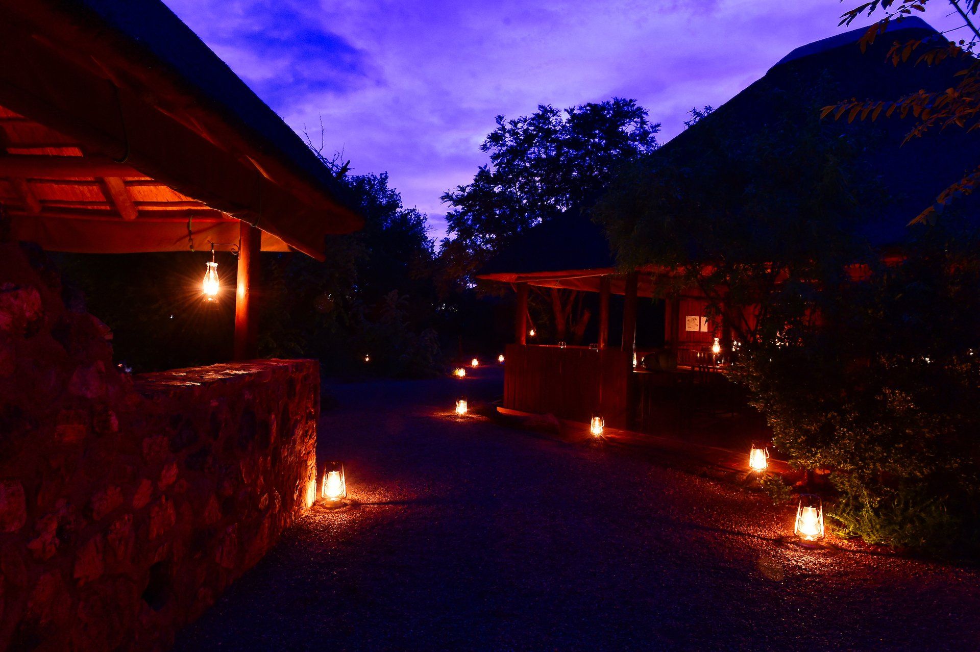 A purple sky with a few lanterns in the foreground