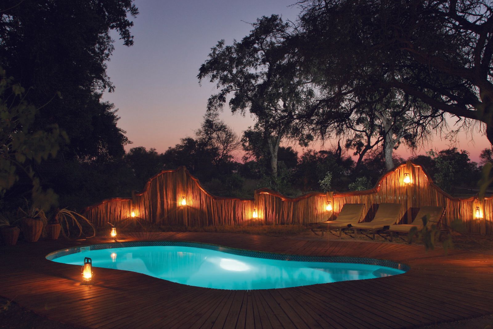 A large swimming pool is lit up at night
