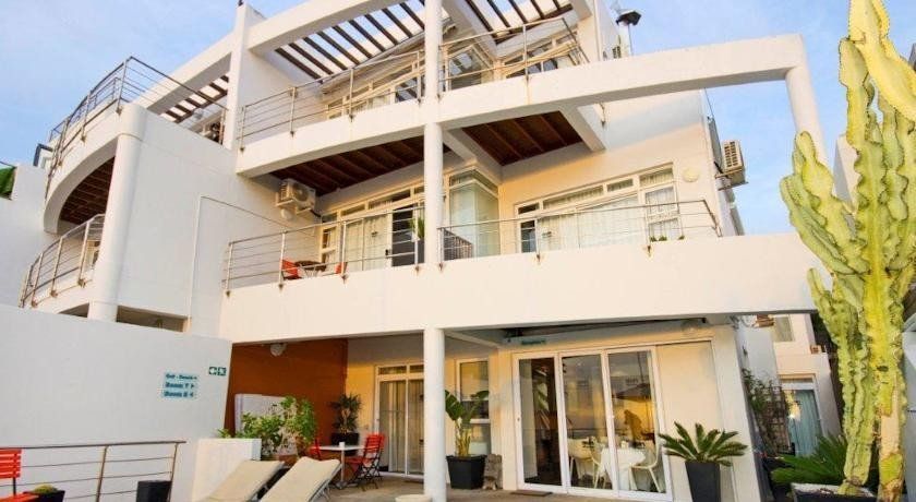 A large white house with a lot of windows and balconies