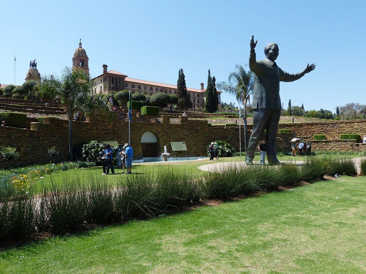 A statue of nelson mandela is standing in a park