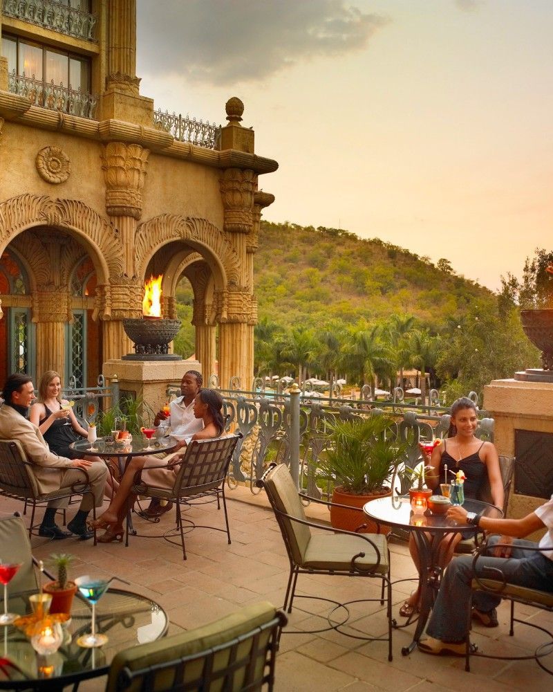 A group of people are sitting at tables outside of a building