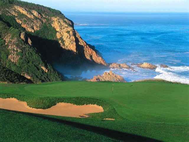 A golf course on a cliff overlooking the ocean
