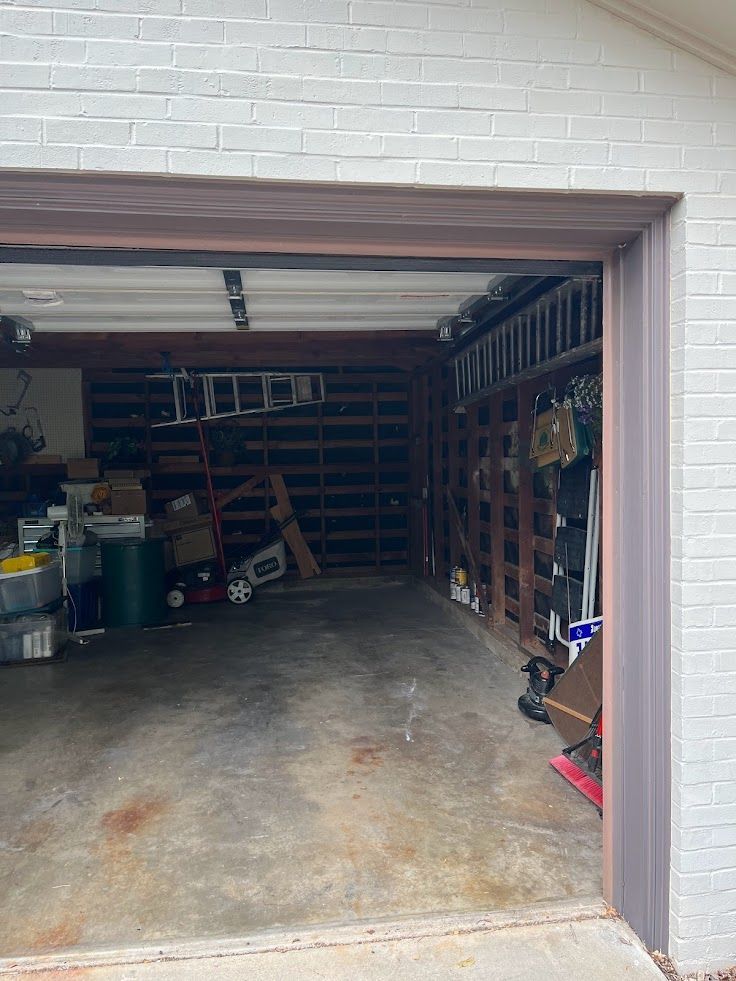 A garage filled with lots of junk and a ladder.