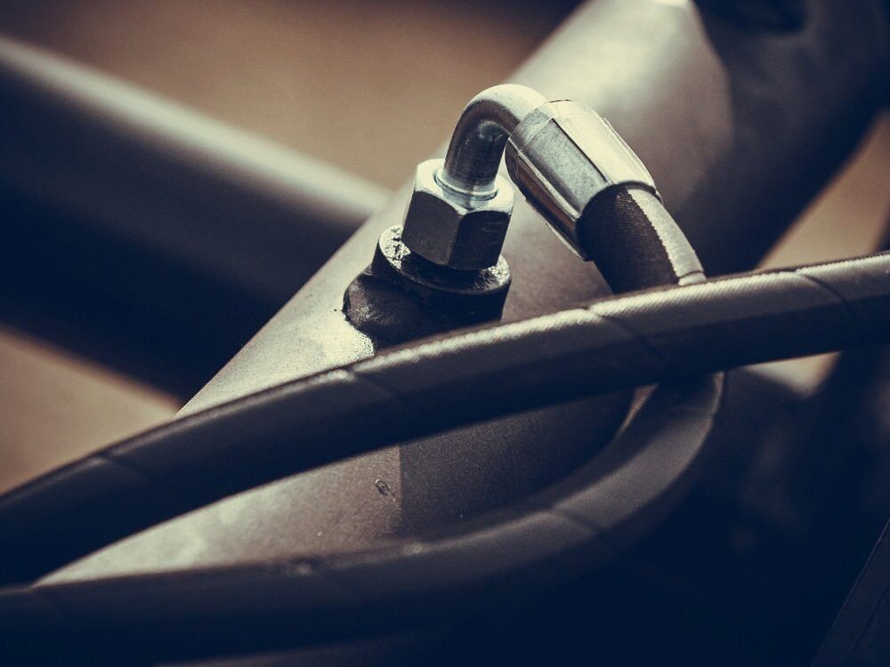 A Metal Pipe With A Hose Attached To It — Hitemp Compressed Air Services in Southern Highlands, NSW