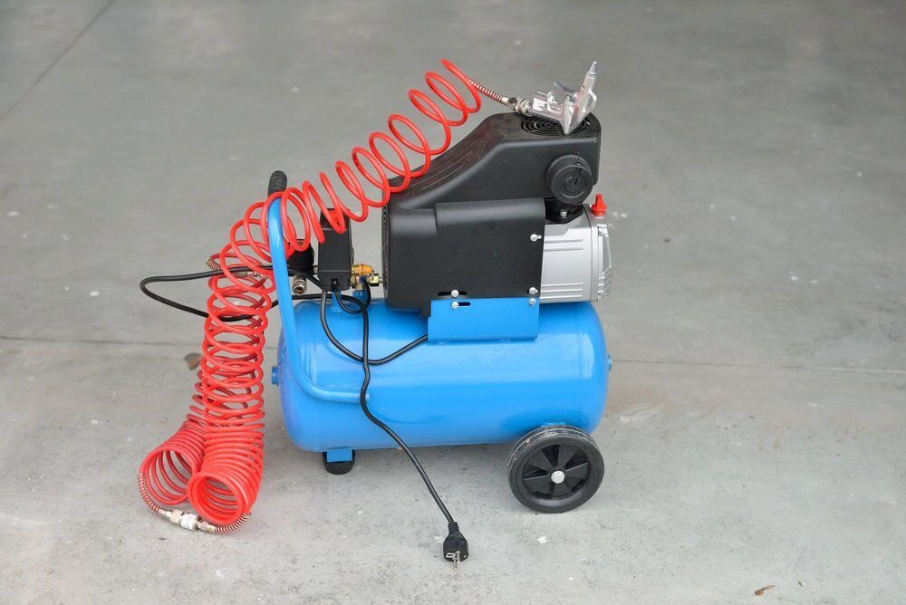 A Blue Air Compressor With A Red Hose Attached To It — Hitemp Compressed Air Services in Campbelltown, NSW