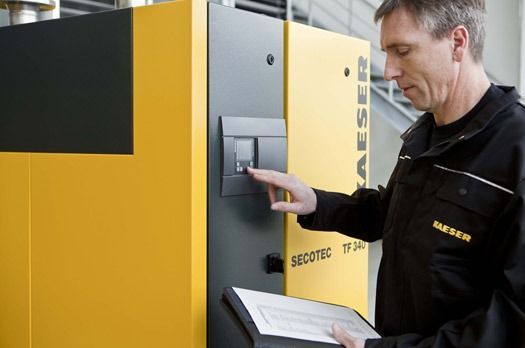 Man Inspecting A Kaeser Air Compressor — Hitemp Compressed Air Services in Fairy Meadow, NSW