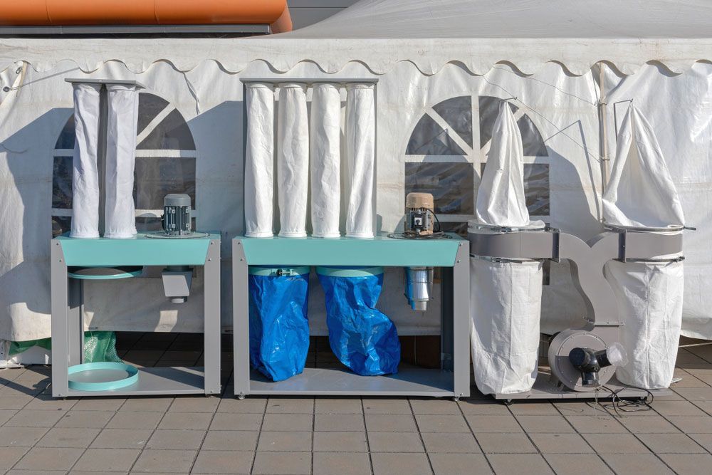 Dust Filters Sitting In Front Of A White Tent — Hitemp Compressed Air Services in Fairy Meadow, NSW