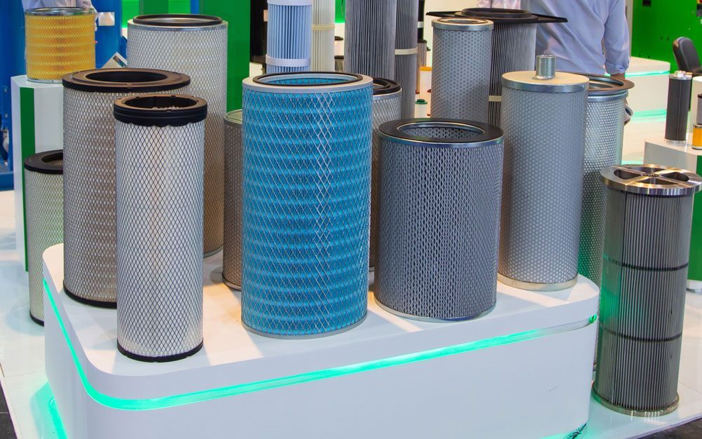 Different Types Of Air Compressor Filters On A Table — Hitemp Compressed Air Services in Fairy Meadow, NSW