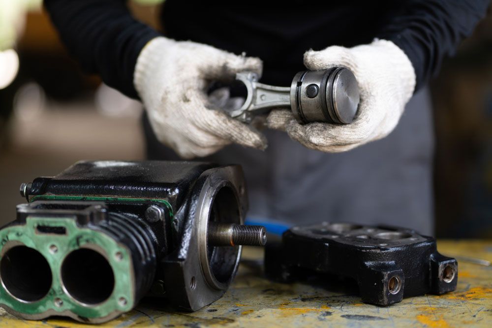 Person Holding An Air Compressor Part — Hitemp Compressed Air Services in Fairy Meadow, NSW
