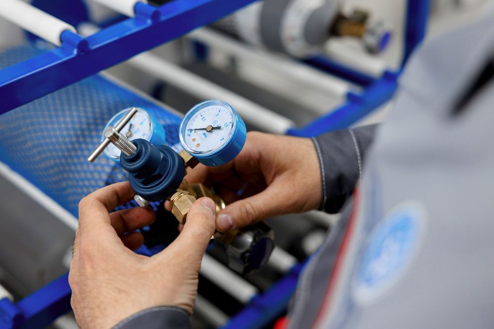 Man Working On An Air Pressure Gauge — Hitemp Compressed Air Services in Fairy Meadow, NSW