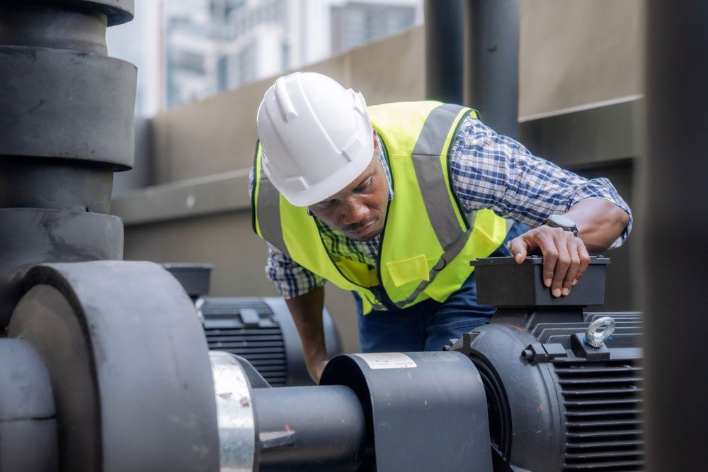 Worker Checking The Air On The Compressor — Hitemp Compressed Air Services in Campbelltown, NSW