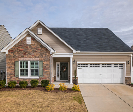 A house with a brick facade and a white garage door