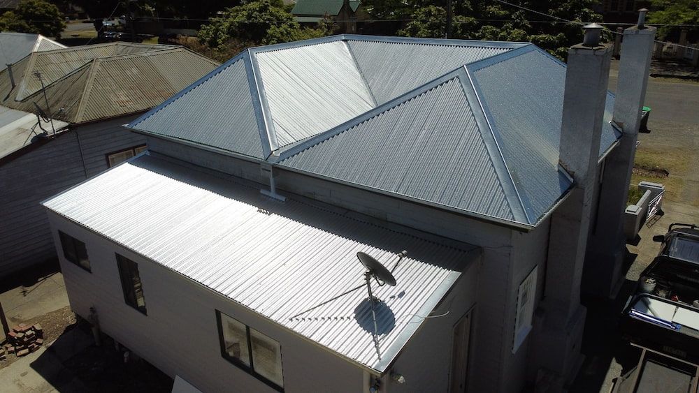 An Aerial View of a House With a Satellite Dish on the Roof — iFix Roofing Bendigo in Kangaroo Flat, VIC
