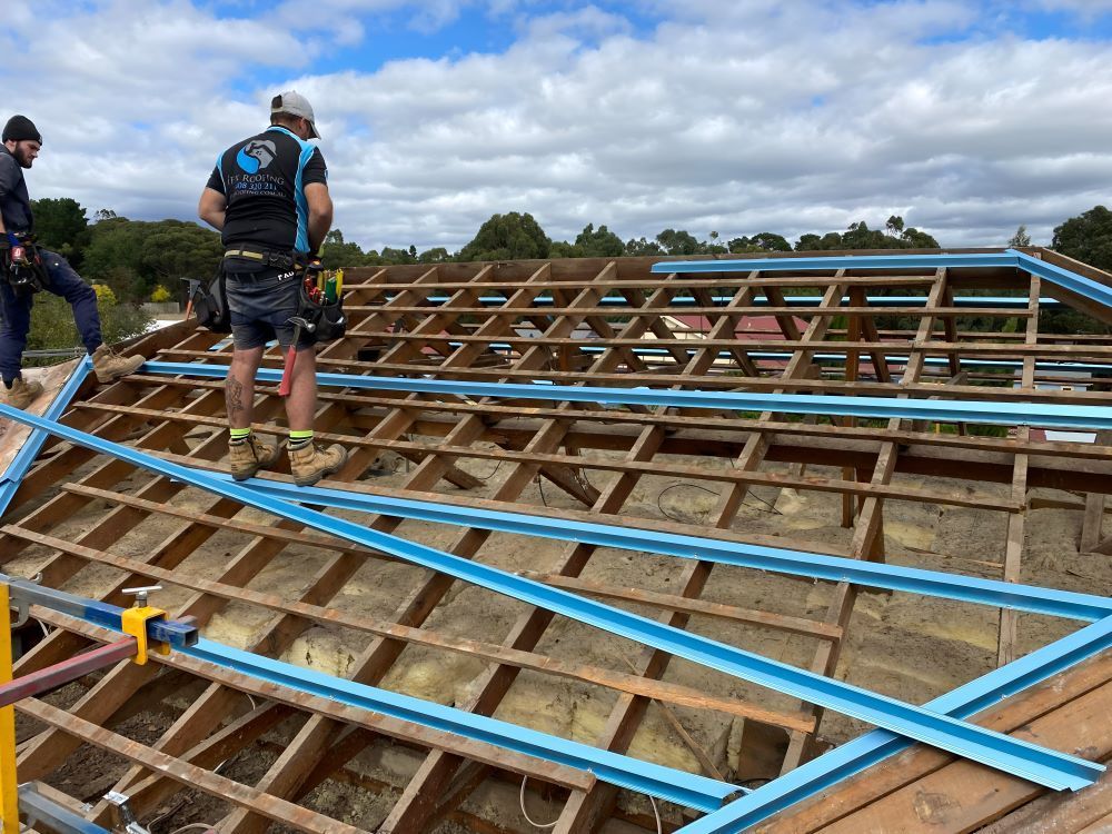A Group of Men Are Working on a Wooden Roof — iFix Roofing Bendigo in Kangaroo Flat, VIC
