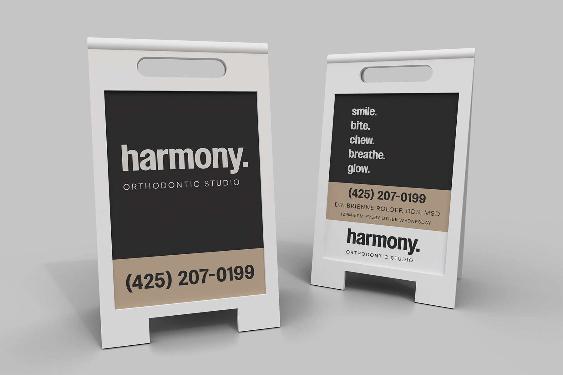 Two white A-frame signs with black backgrounds and white text, advertising 