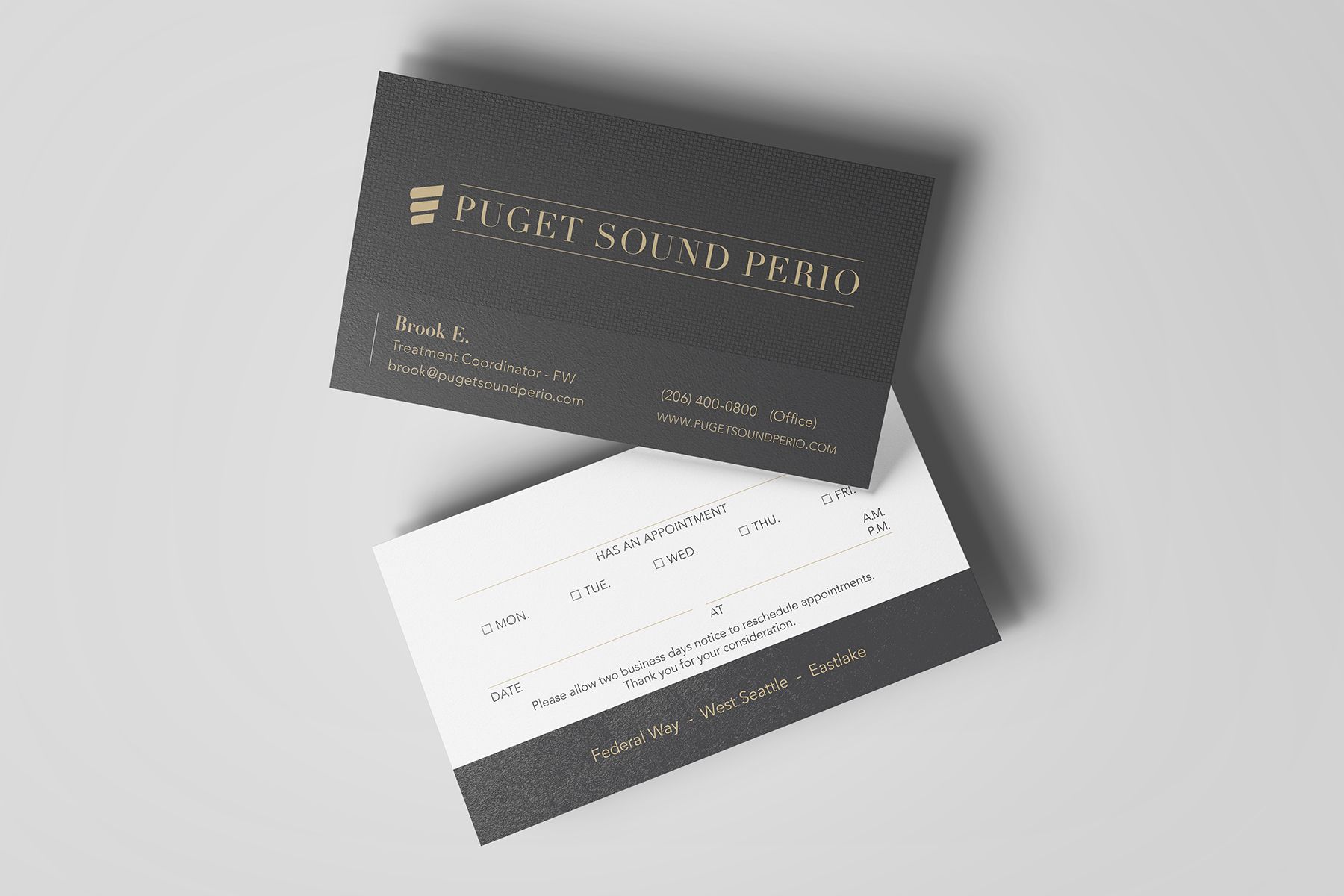 Two business cards; one black with gold text, one white with black text, stacked.