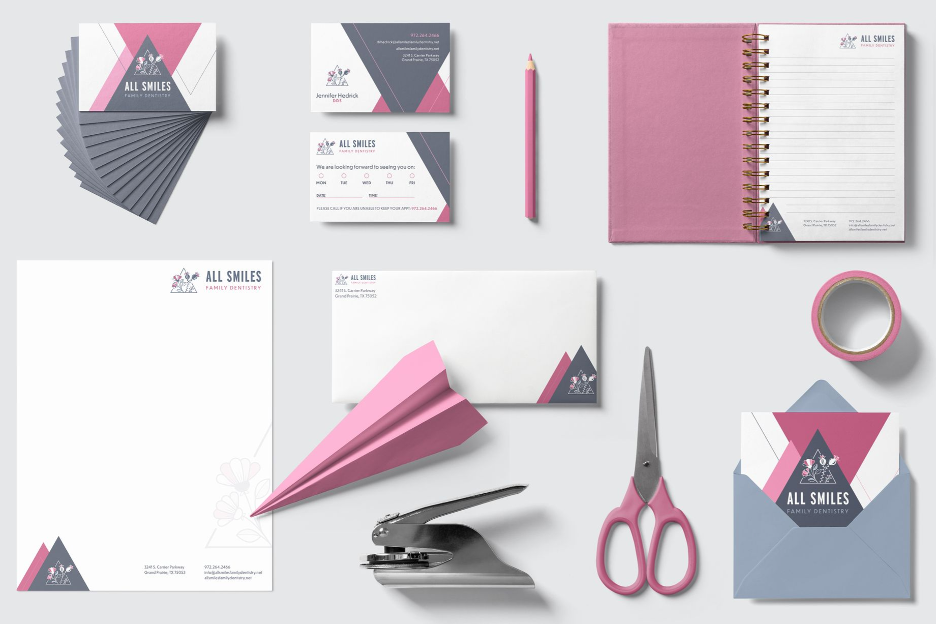 Stationery mockup featuring pink and gray branding: business cards, notepad, envelope, paper airplane, scissors.