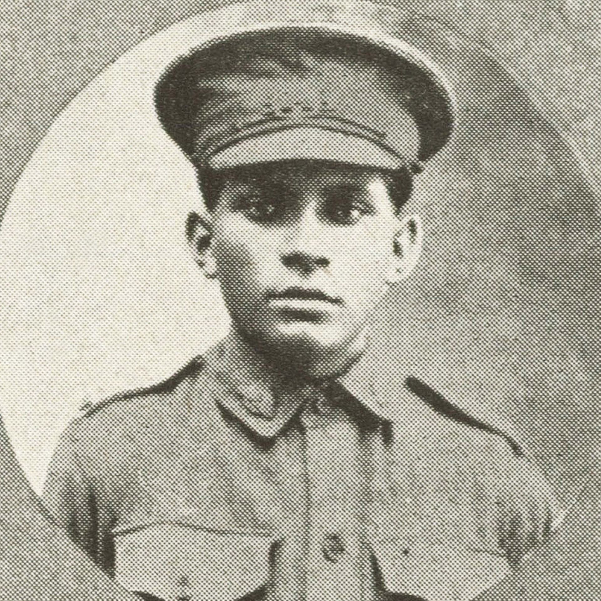 Young man in military uniform and cap, centered in a framed oval portrait.