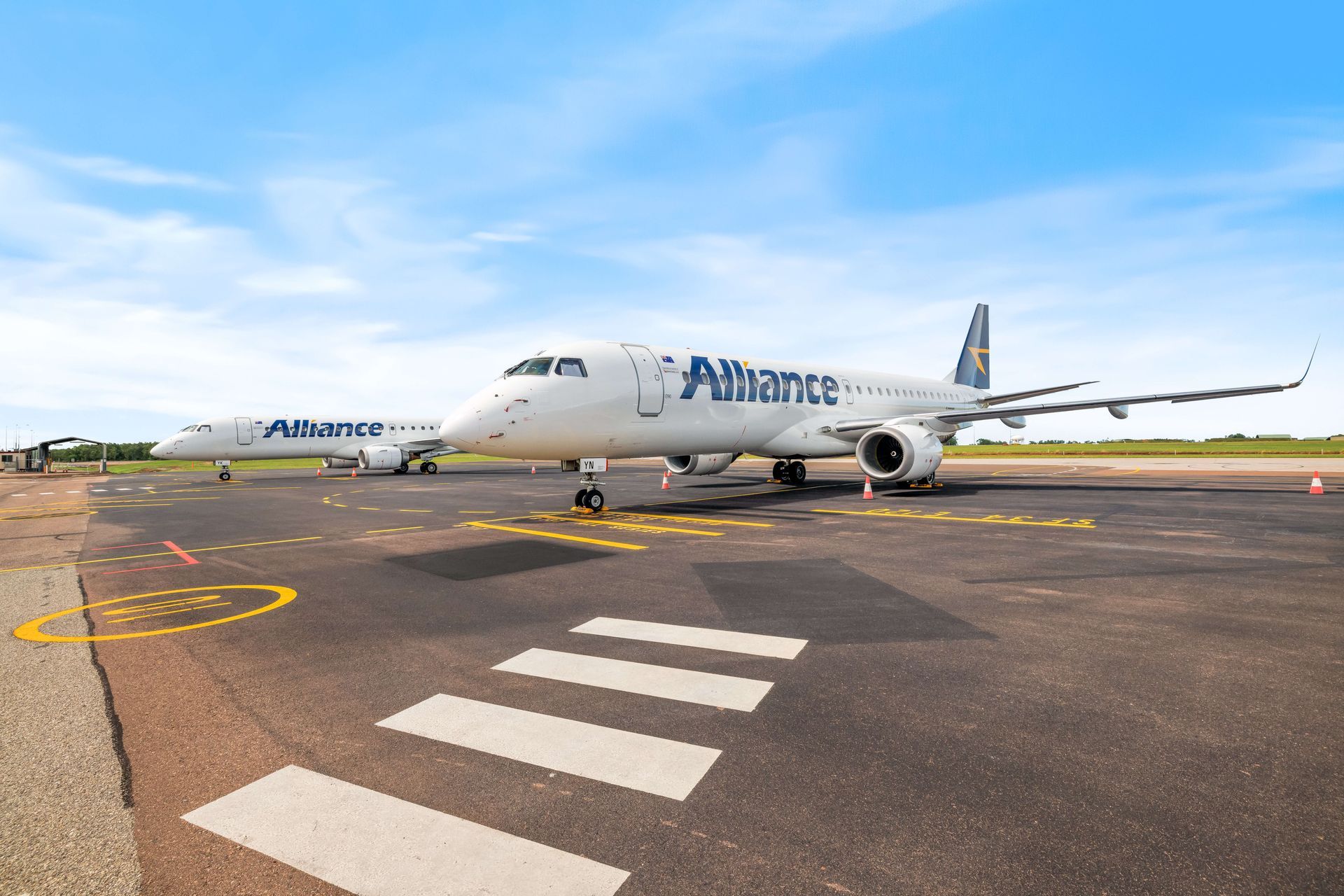 An alliance airplane is parked on the runway of an airport.