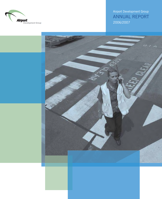 A man is walking across a crosswalk and talking on a cell phone