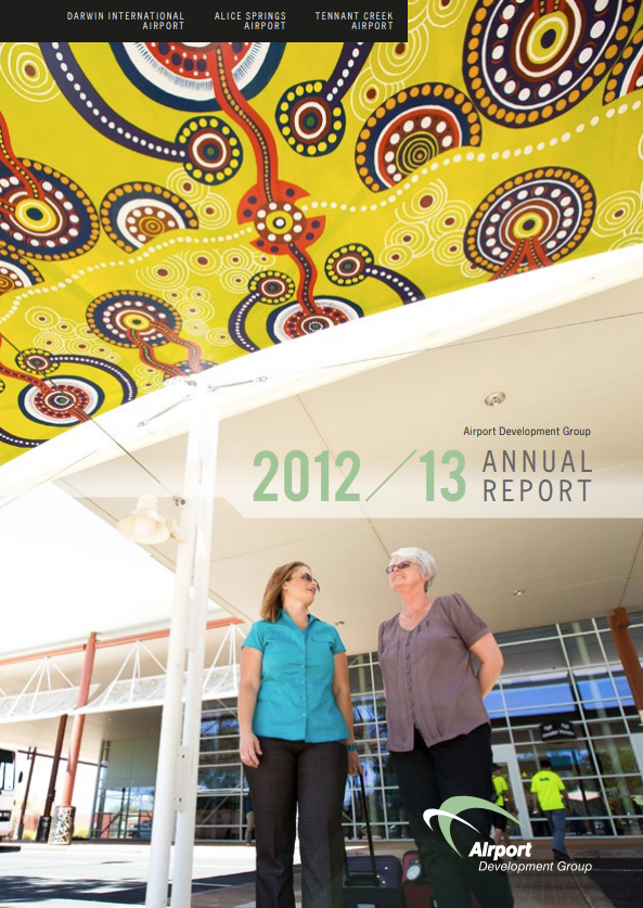 Two women under awning with Aboriginal art, 2012-13 Annual Report, airport setting.
