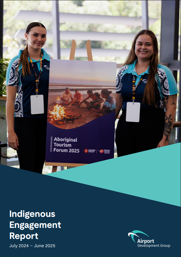 Two women hold a report titled 