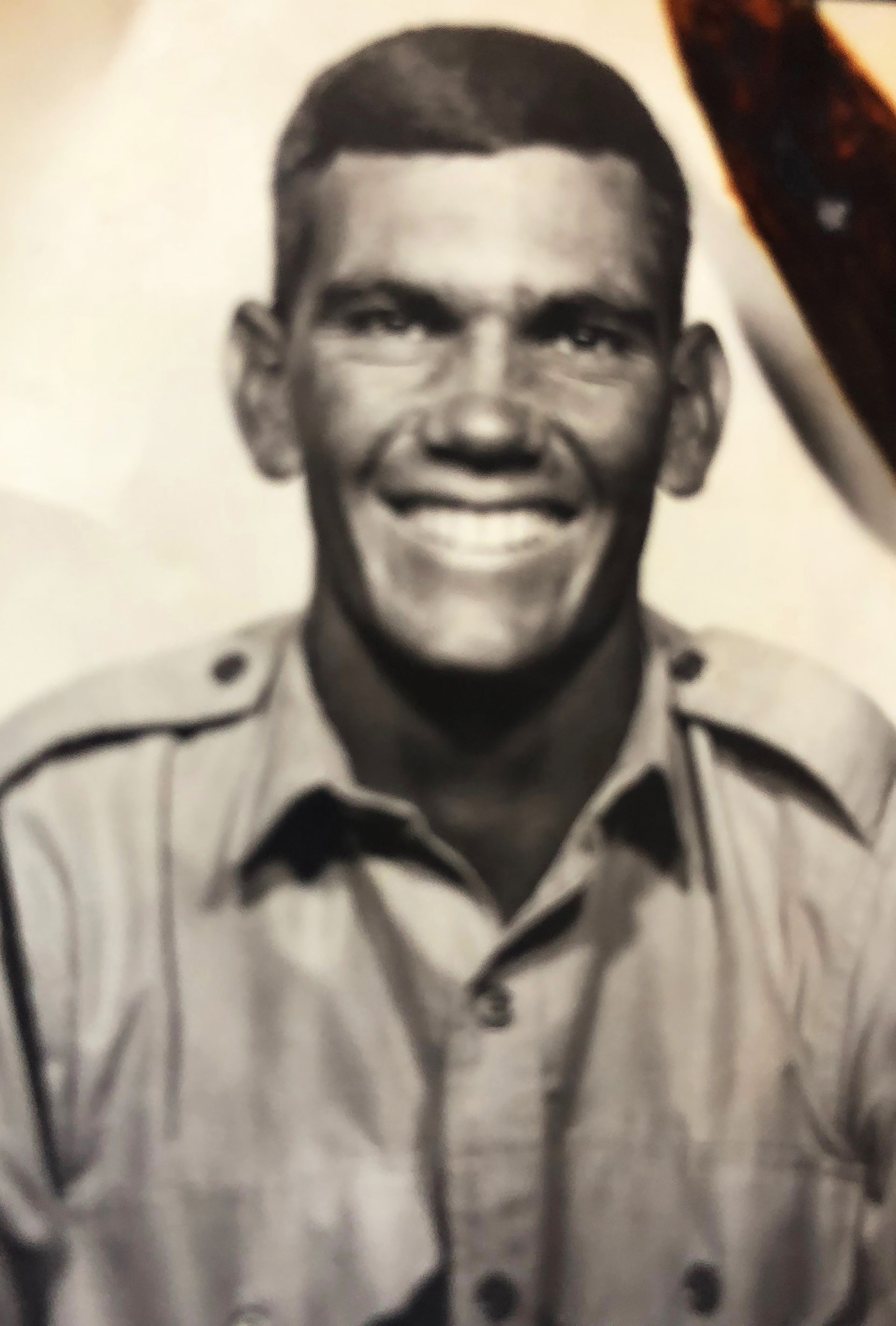 Smiling young man in military uniform.