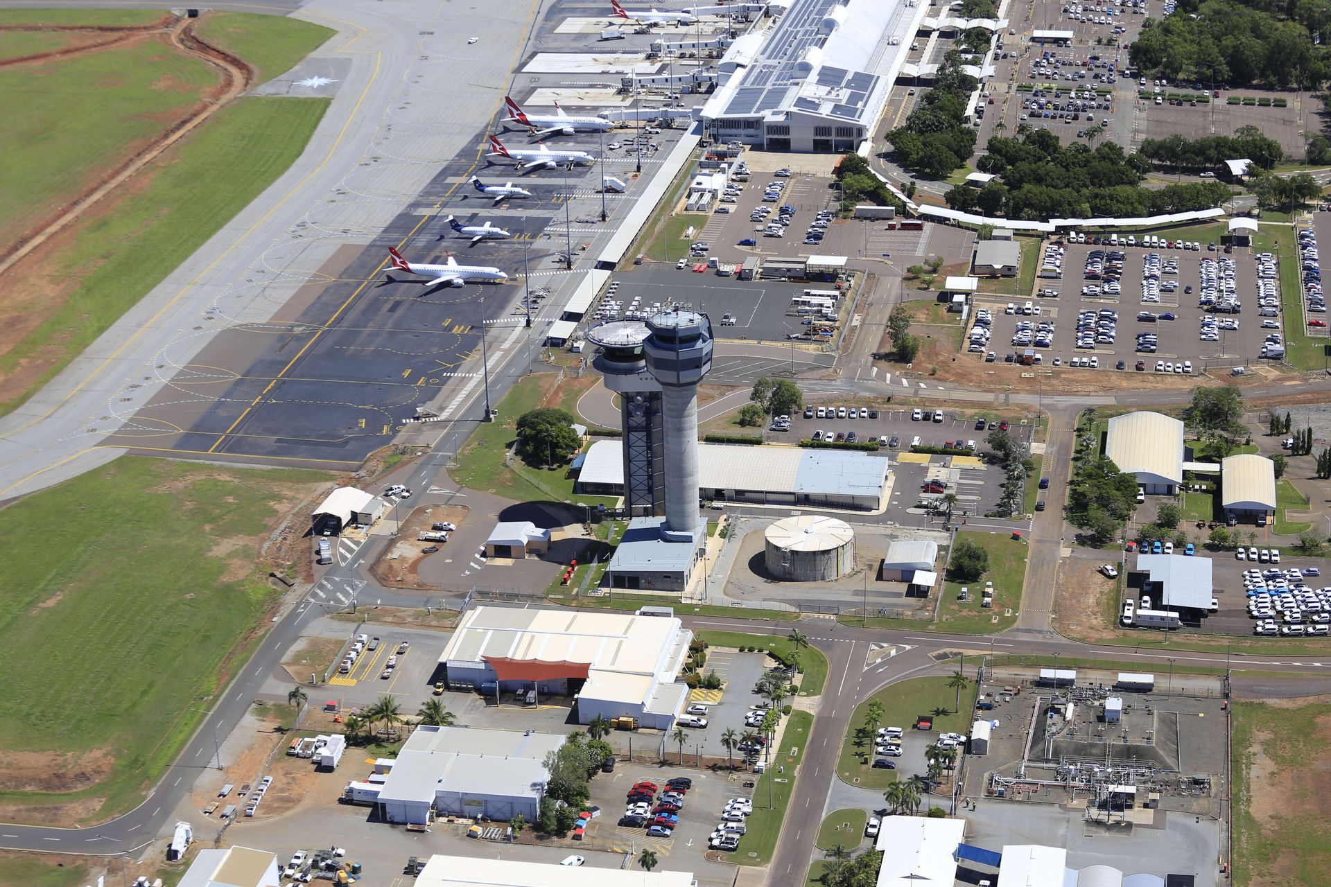 An aerial view of an airport with planes parked on the runways