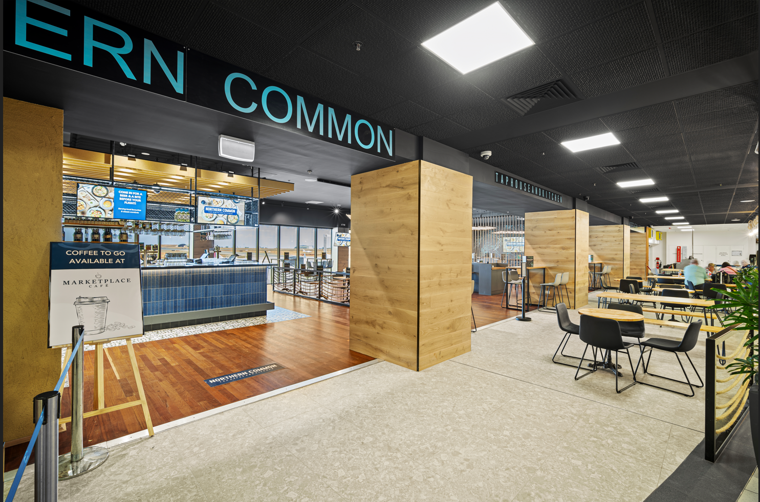 A restaurant with tables and chairs and a sign that says ern common