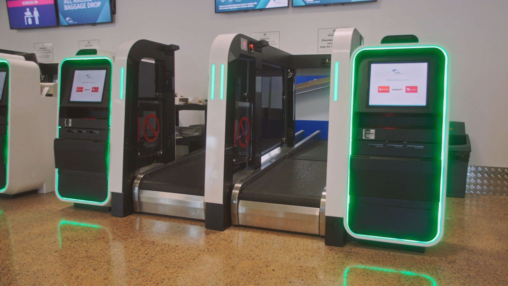 A bunch of kiosks are sitting next to each other in an airport.