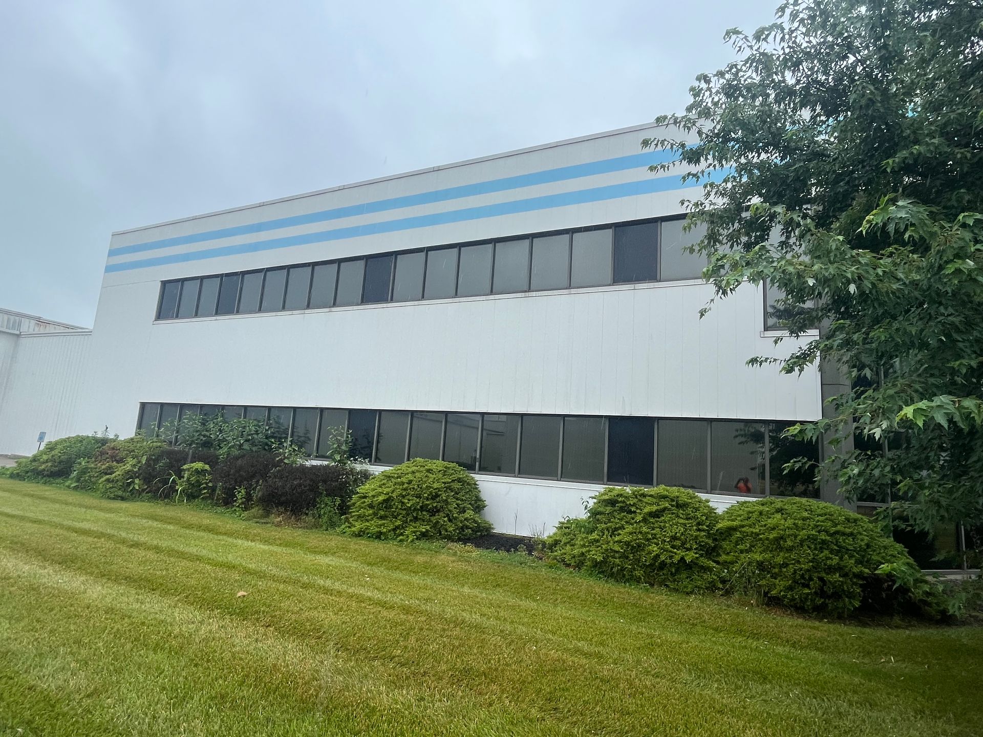 Hand troweling cement on a gray concrete wall.