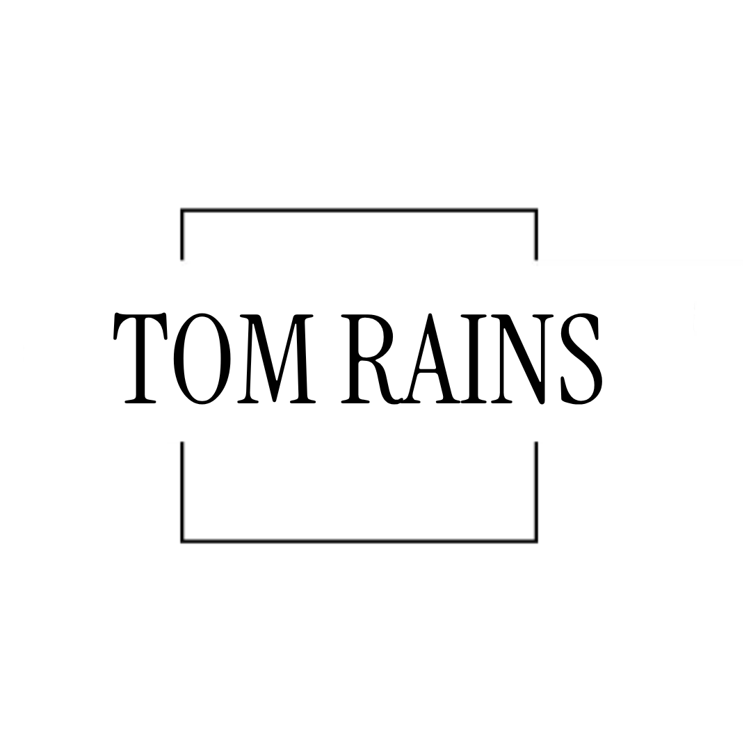 Tom Rains in black serif text framed by thin black brackets on a white background