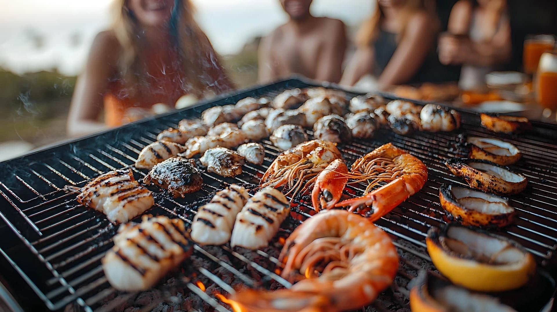 A group of people are sitting at a table eating food on a grill.
