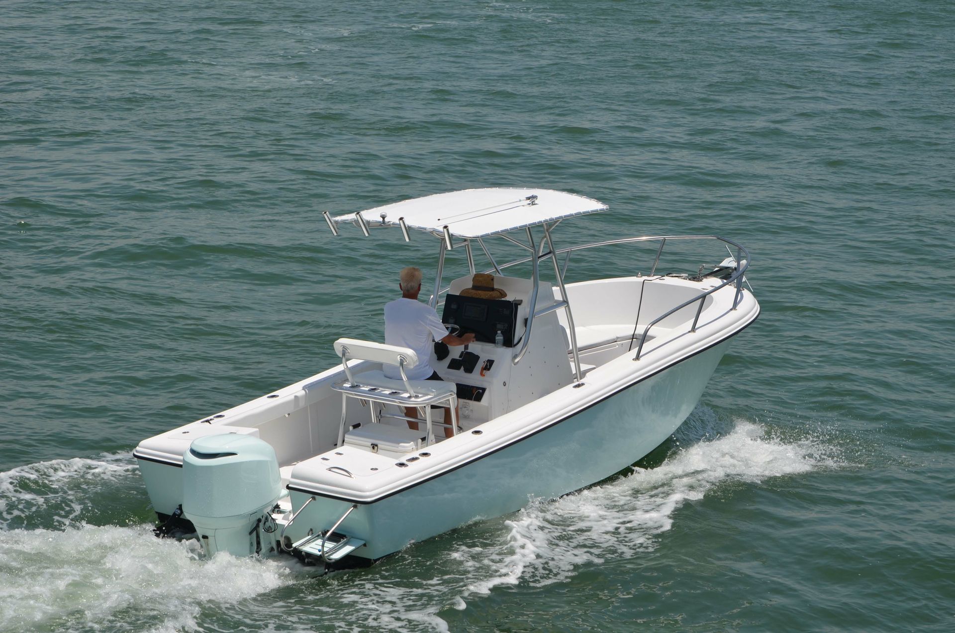 An aerial view of a sailboat in the ocean.