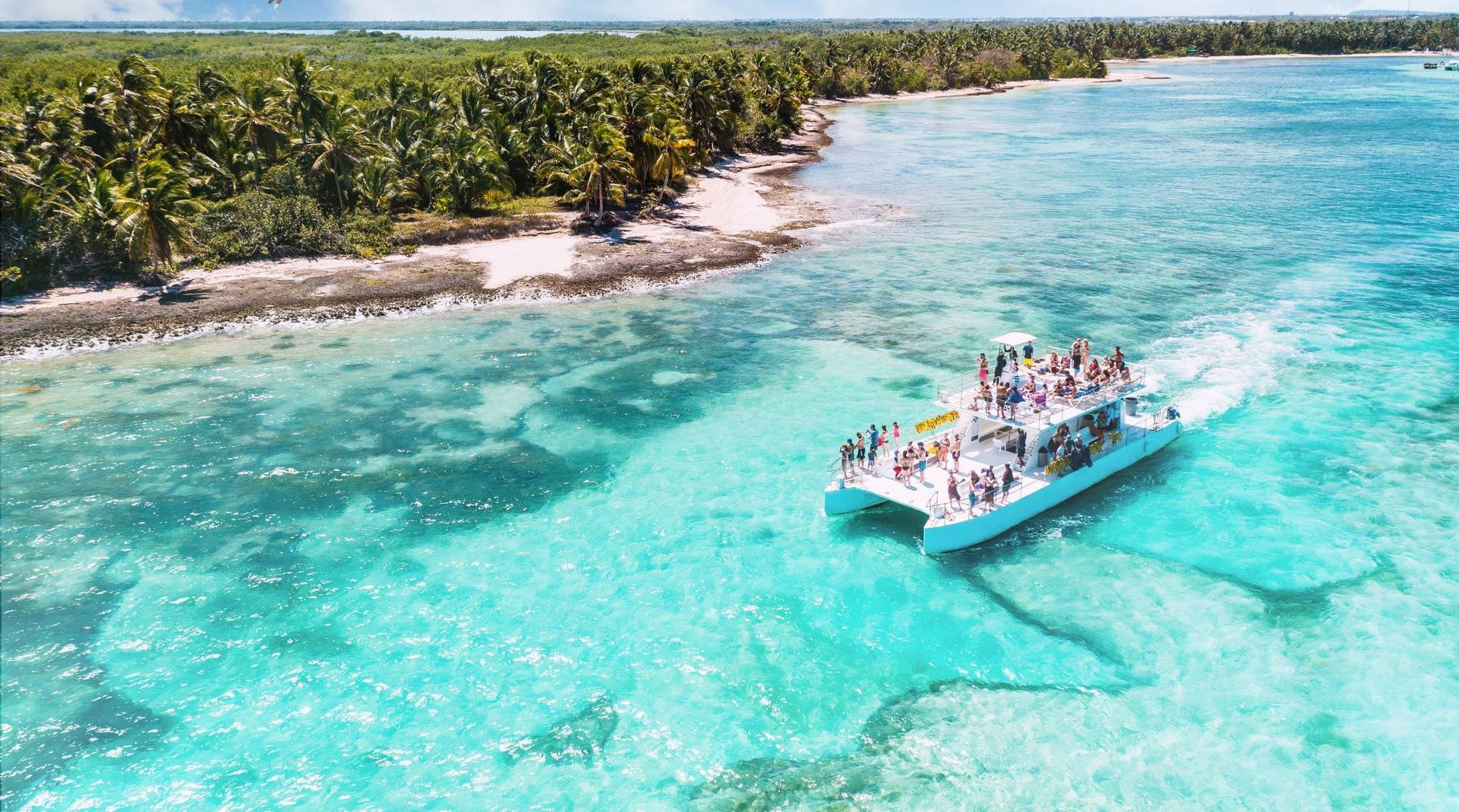 An aerial view of a boat filled with people in the ocean.