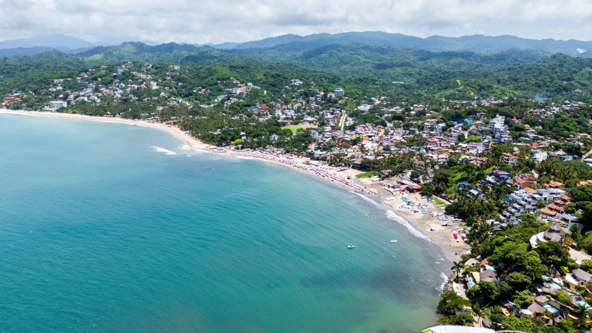 An aerial view of a boat filled with people in the ocean.