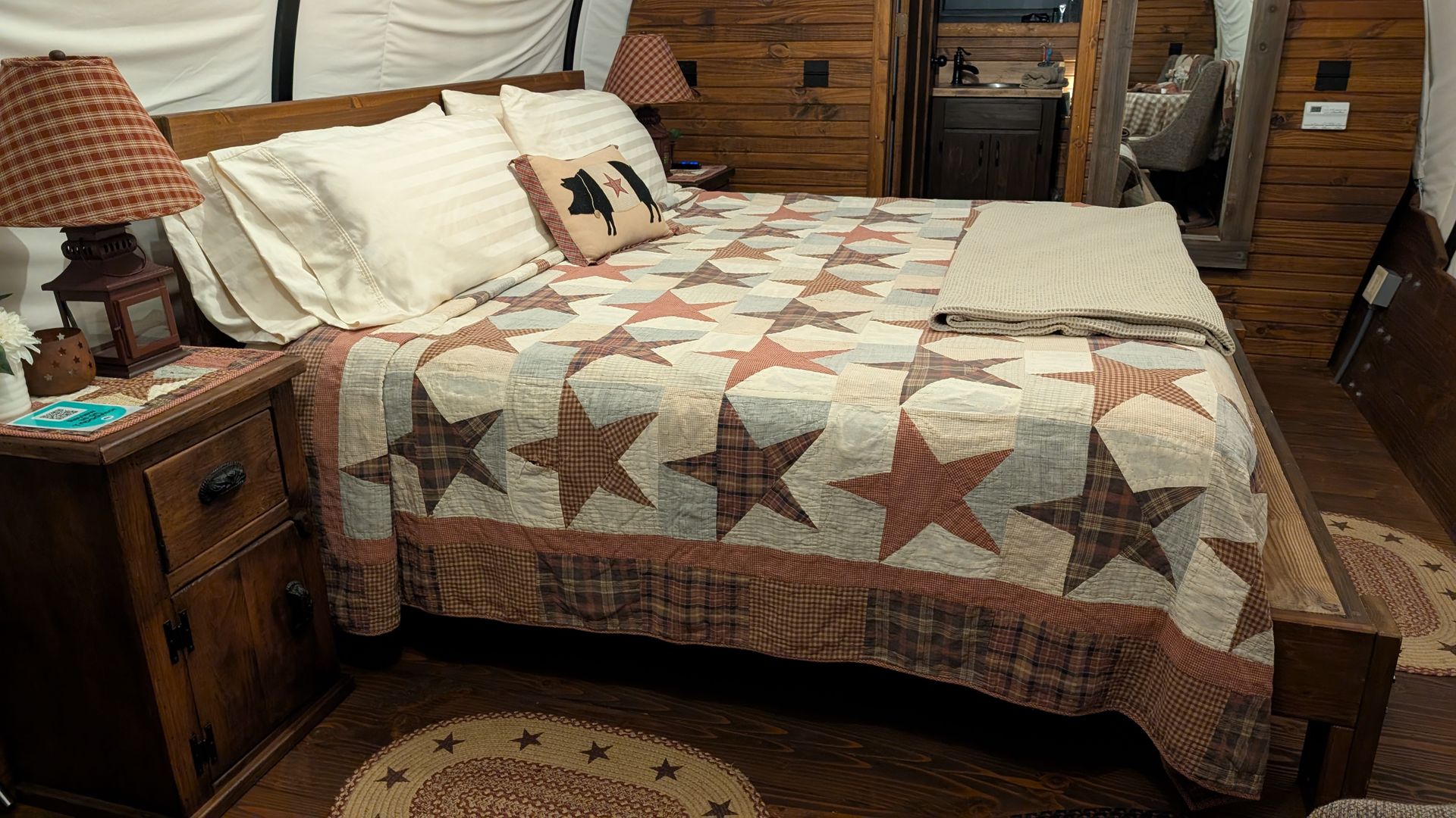 Interior of covered wagon king bed spacious living area and restroom
