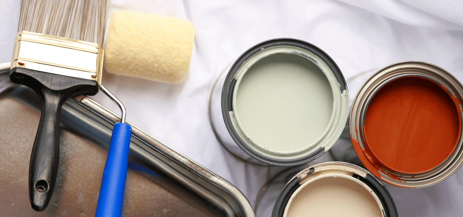3 cans of enamel paint in red, beige, and pale green, for painting trim and doors