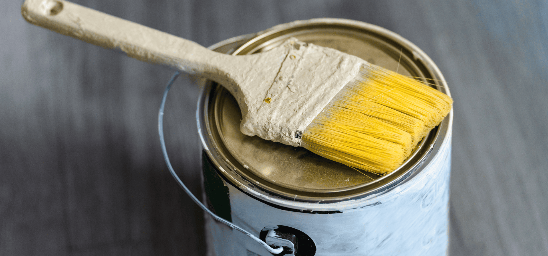 A can of leftover yellow oil-based exterior paint