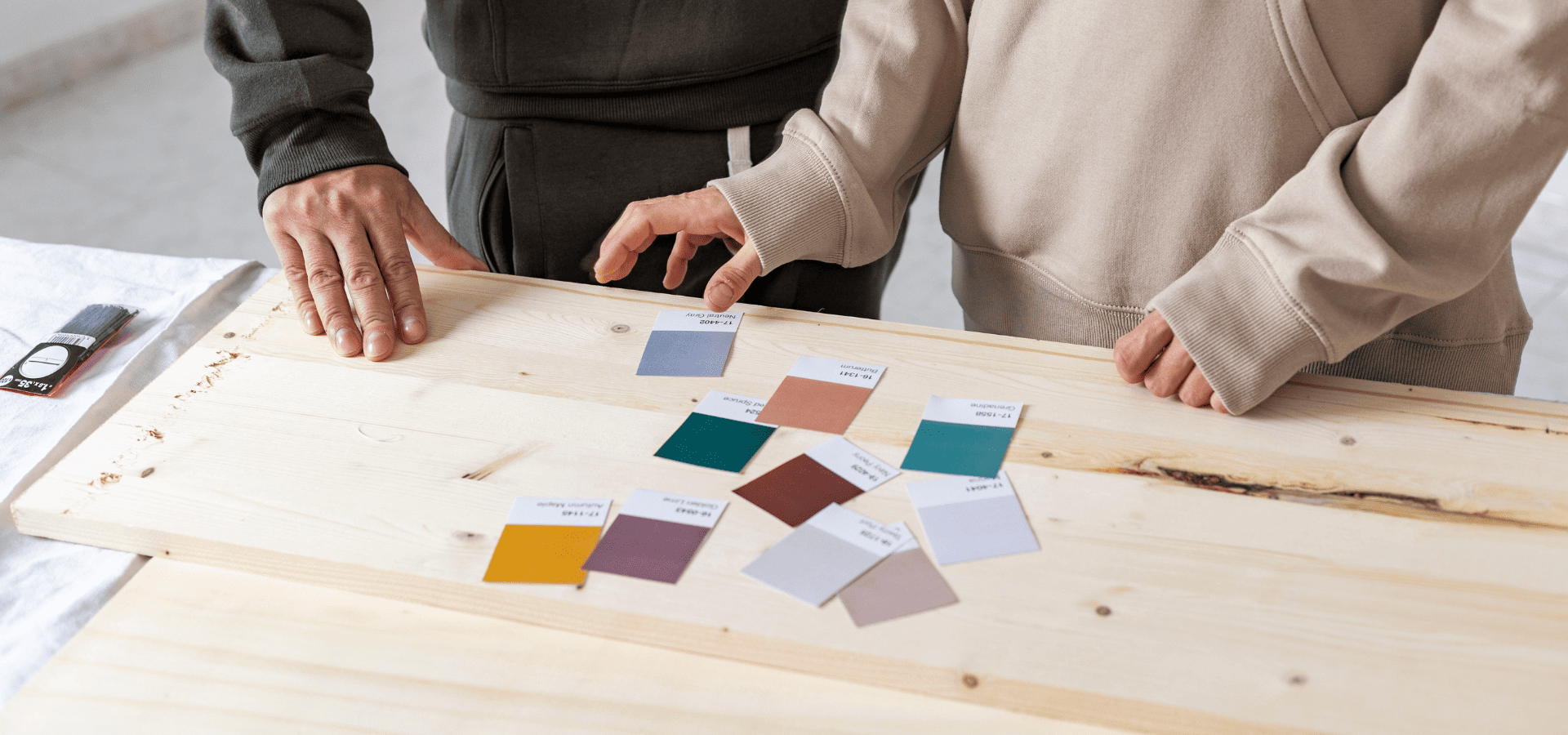 Homeowners looking through paint swatches at Renewed Walls Painting
